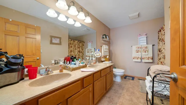 a bathroom with a sink vanity granite and a mirror