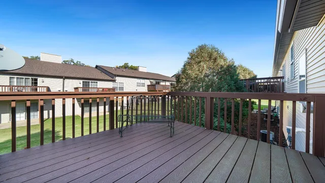 a view of a wooden deck and a yard
