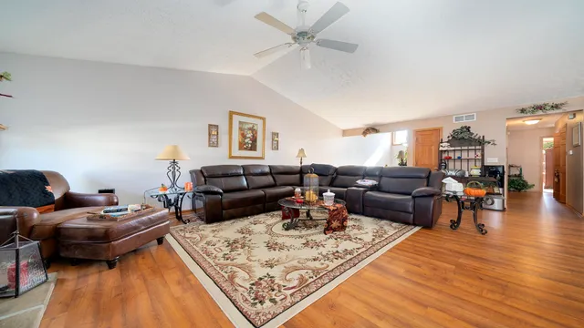 a living room with furniture and a wooden floor