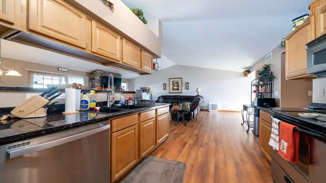 a kitchen with lots of counter top space and wooden floor