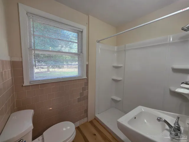 a bathroom with a sink a mirror and a shower