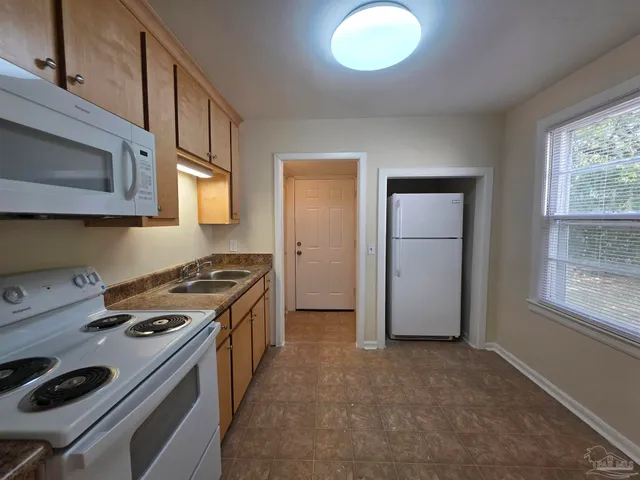 a kitchen with a stove and a microwave