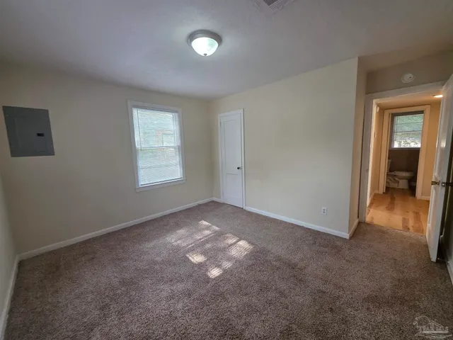 an empty room with a empty space and windows