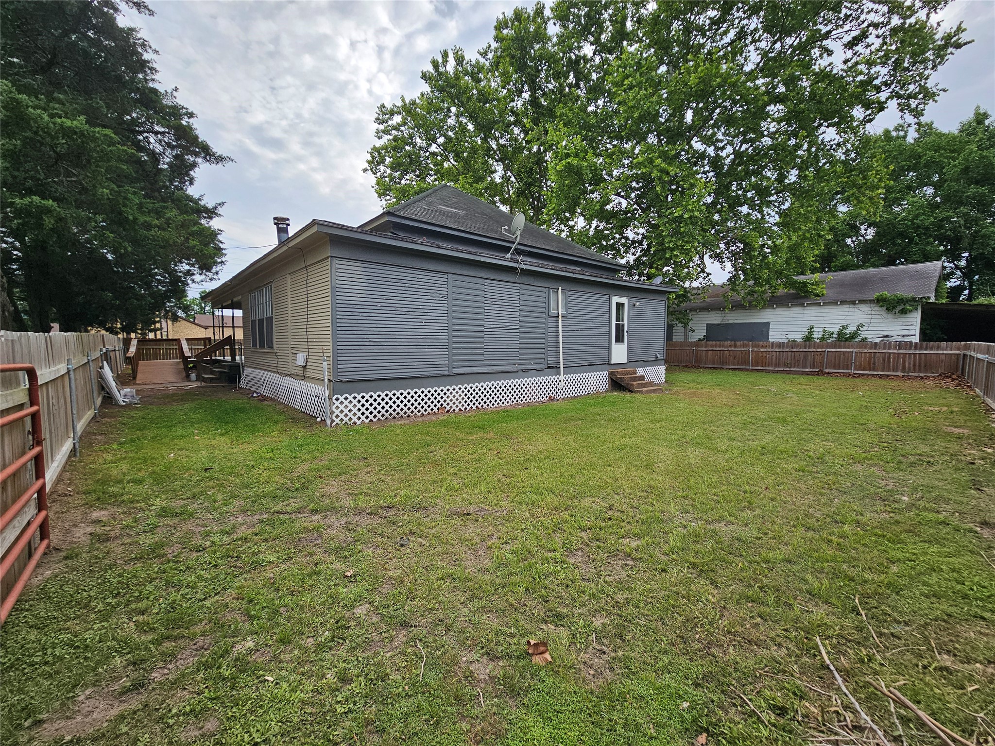 11 Smith Street Shepherd, TX 77371 - Photo 6 of 31 a view of a house with a yard and sitting area
