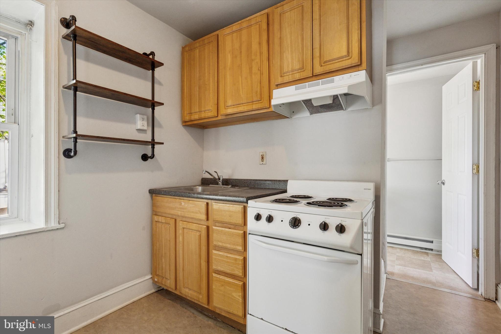 4381 Pechin Street Philadelphia, PA 19128 - Photo 12 of 46 a kitchen with white cabinets and white appliances