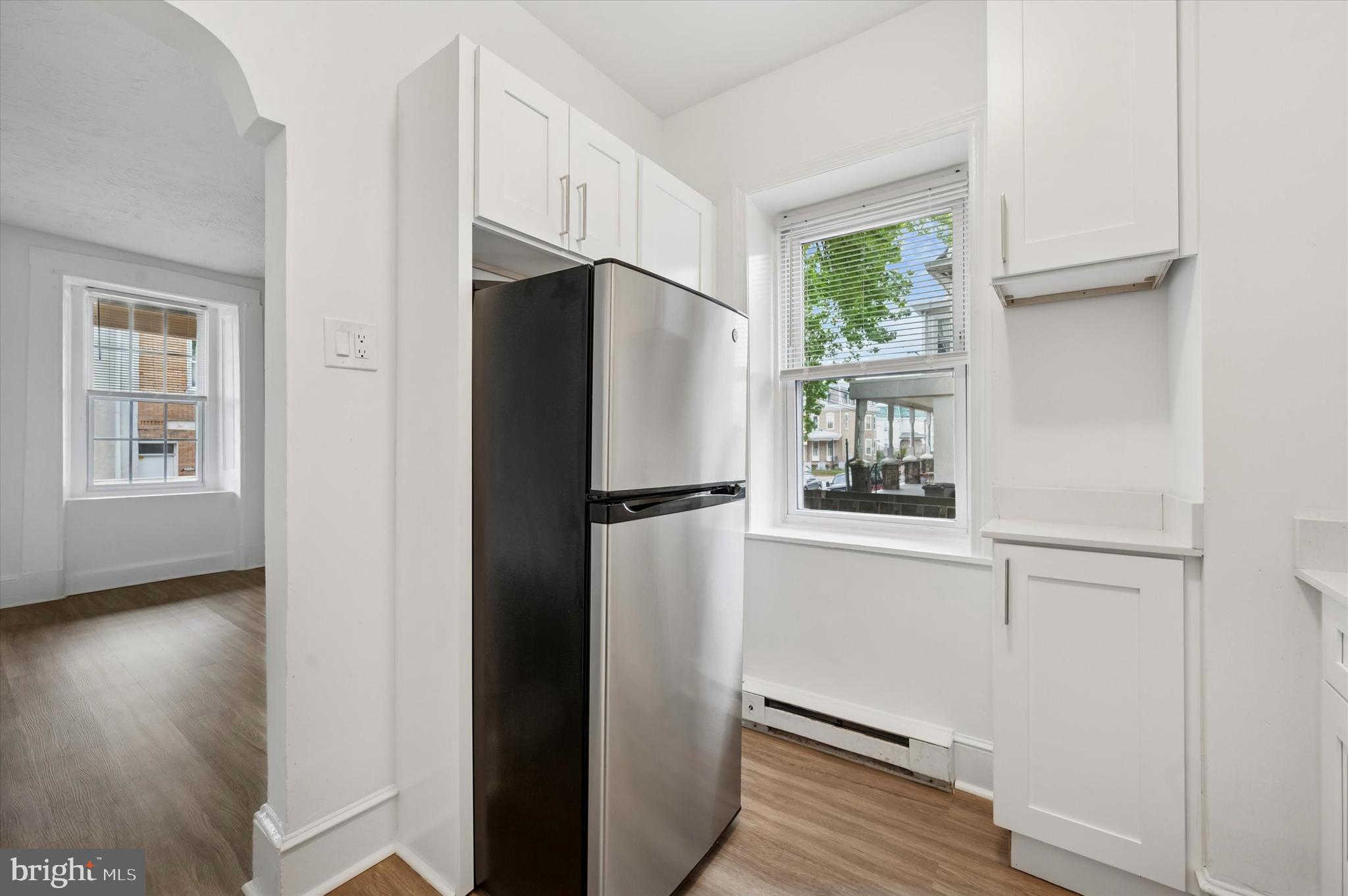 4381 Pechin Street Philadelphia, PA 19128 - Photo 19 of 46 a white refrigerator freezer and a wooden floor