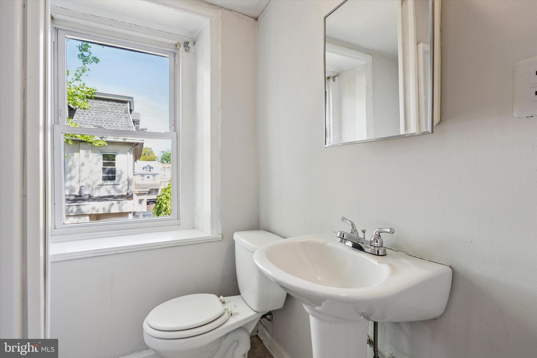 4381 Pechin Street Philadelphia, PA 19128 - Photo 22 of 46 a bathroom with a sink a mirror and a toilet