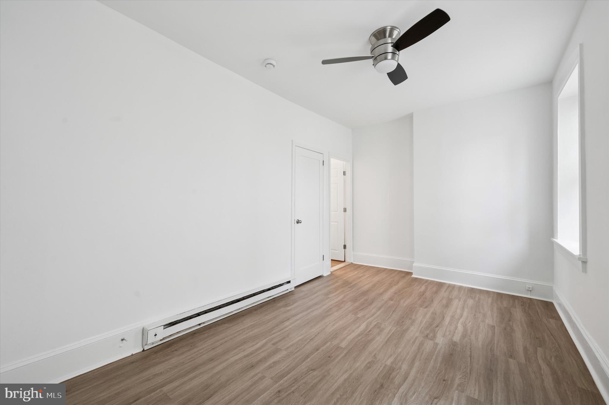 4381 Pechin Street Philadelphia, PA 19128 - Photo 27 of 46 an empty room with wooden floor ceiling fan and window