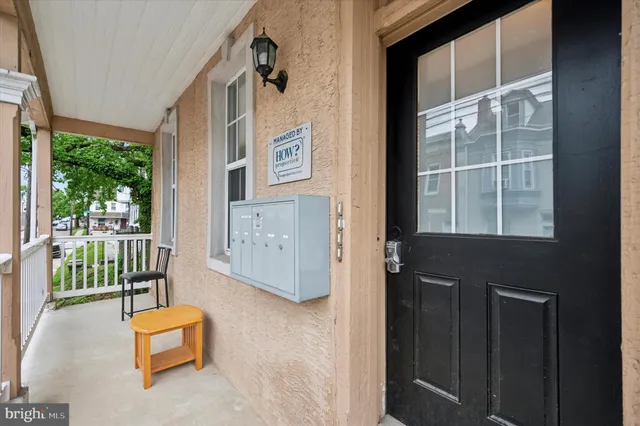 a front door view of a house with a floor to ceiling window