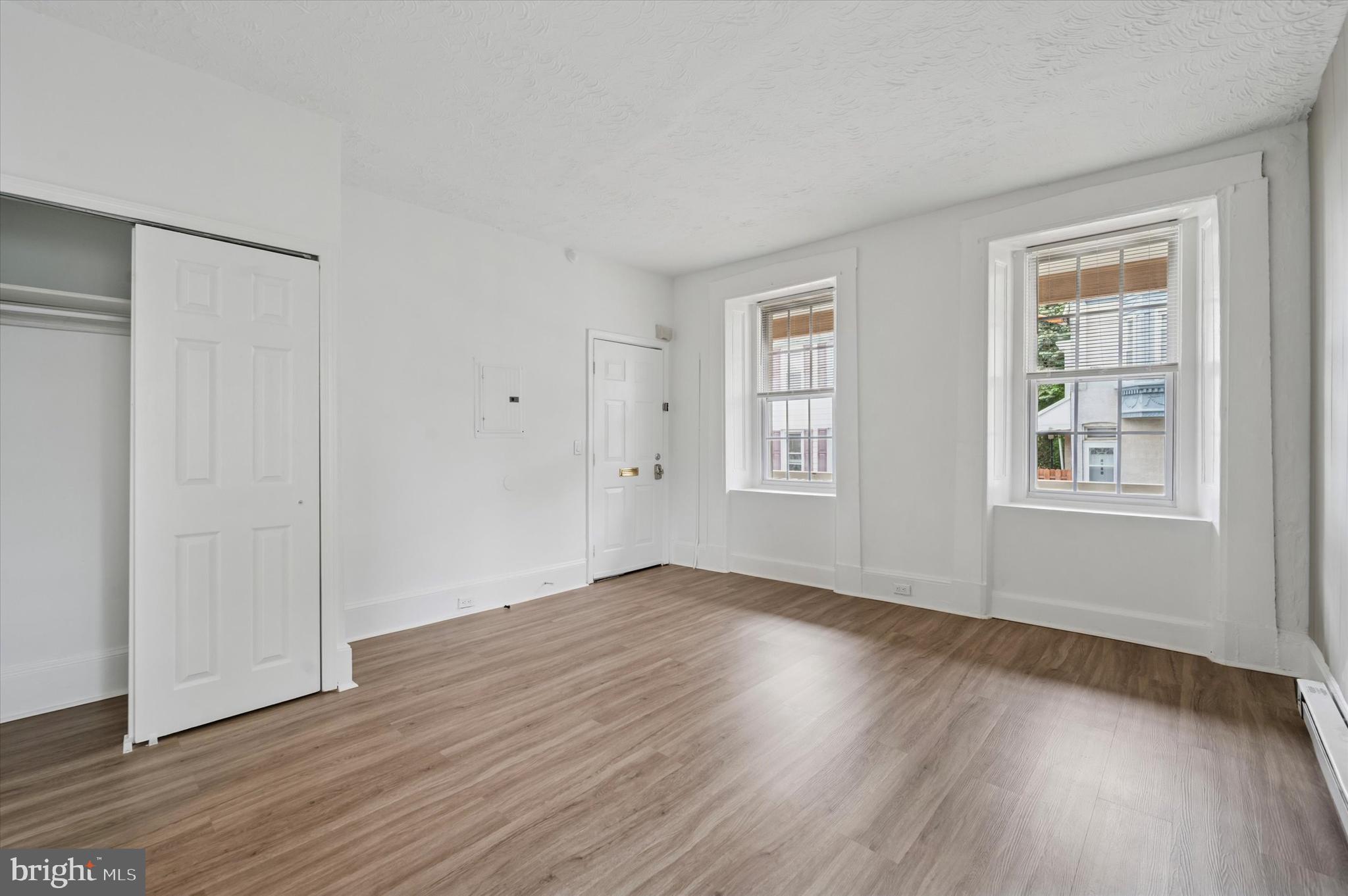 4381 Pechin Street Philadelphia, PA 19128 - Photo 9 of 46 an empty room with wooden floor and windows