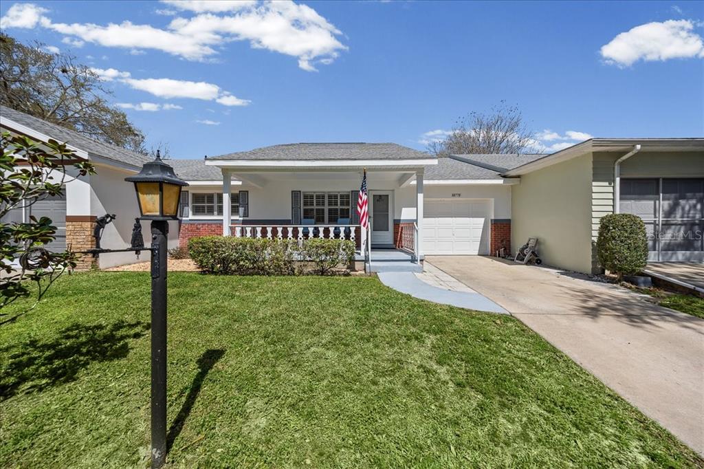 8877 Southwest 96th Street, Unit B Ocala, FL 34481 - Photo 1 of 48 a front view of a house with a yard and porch