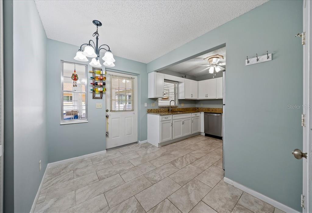 8877 Southwest 96th Street, Unit B Ocala, FL 34481 - Photo 12 of 48 a open kitchen with a sink dishwasher a refrigerator and cabinets