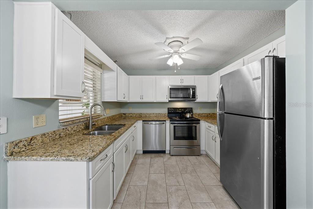 8877 Southwest 96th Street, Unit B Ocala, FL 34481 - Photo 14 of 48 a kitchen with a refrigerator a sink and dishwasher