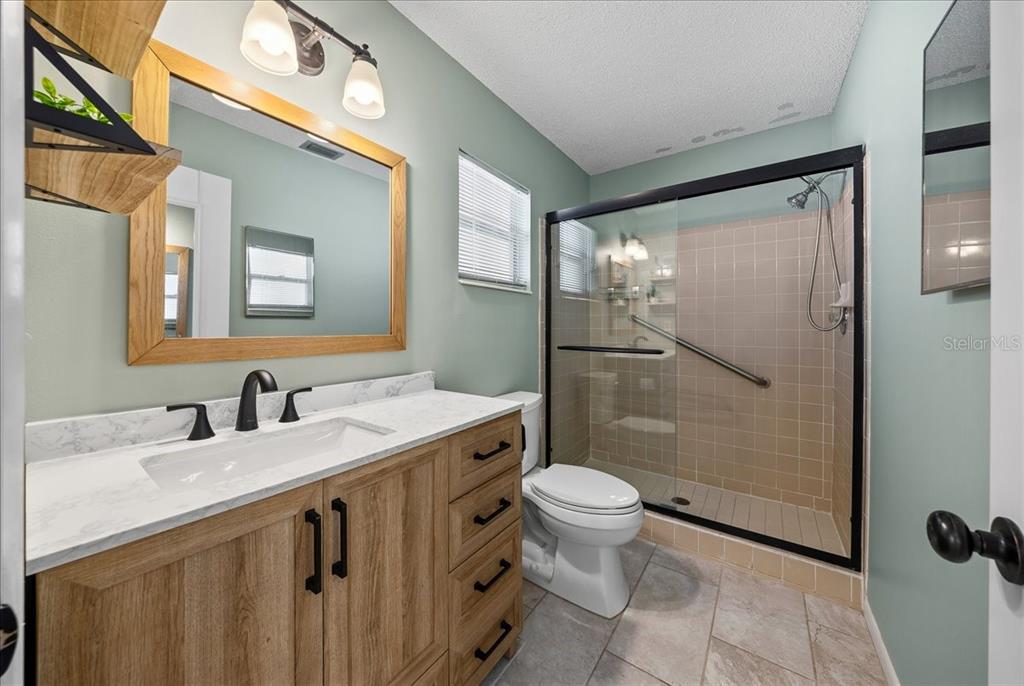 8877 Southwest 96th Street, Unit B Ocala, FL 34481 - Photo 19 of 48 a bathroom with a sink toilet and shower