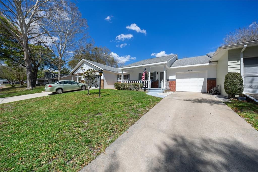 8877 Southwest 96th Street, Unit B Ocala, FL 34481 - Photo 2 of 48 a view of a house with a yard and sitting area