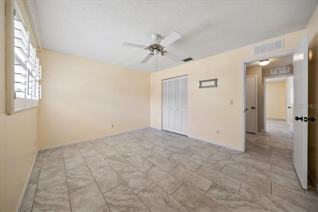 8877 Southwest 96th Street, Unit B Ocala, FL 34481 - Photo 21 of 48 an empty room with windows and fan