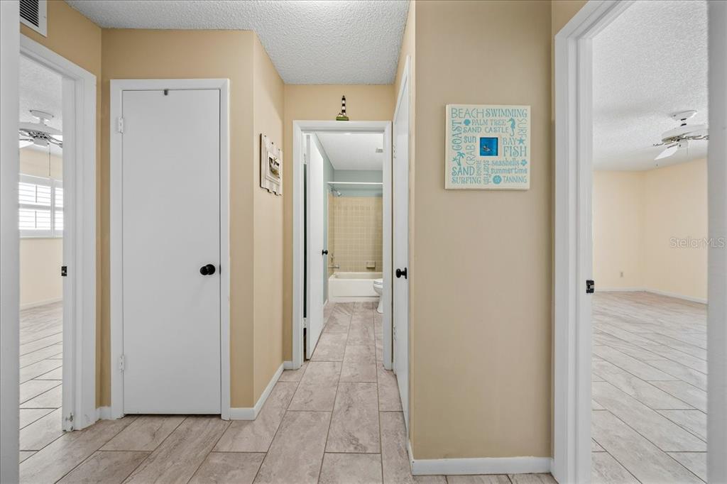 8877 Southwest 96th Street, Unit B Ocala, FL 34481 - Photo 22 of 48 a view of a hallway with wooden floor and a bathroom