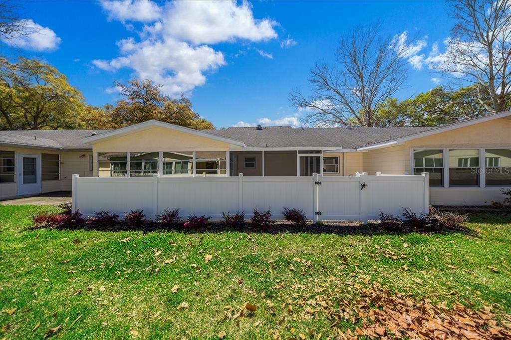 8877 Southwest 96th Street, Unit B Ocala, FL 34481 - Photo 30 of 48 a front view of a house with a garden