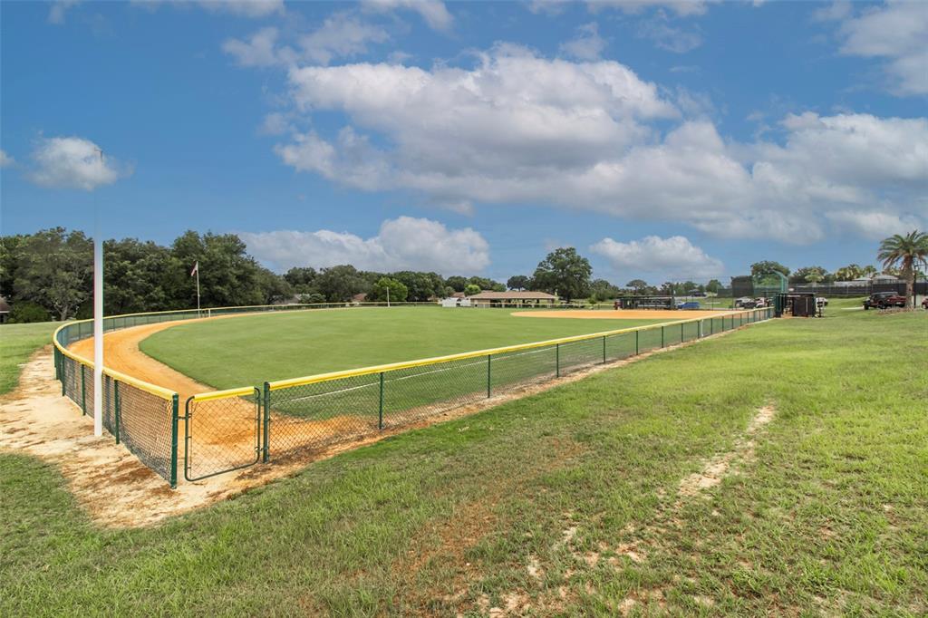 8877 Southwest 96th Street, Unit B Ocala, FL 34481 - Photo 39 of 48 a view of a tennis court with a big yard