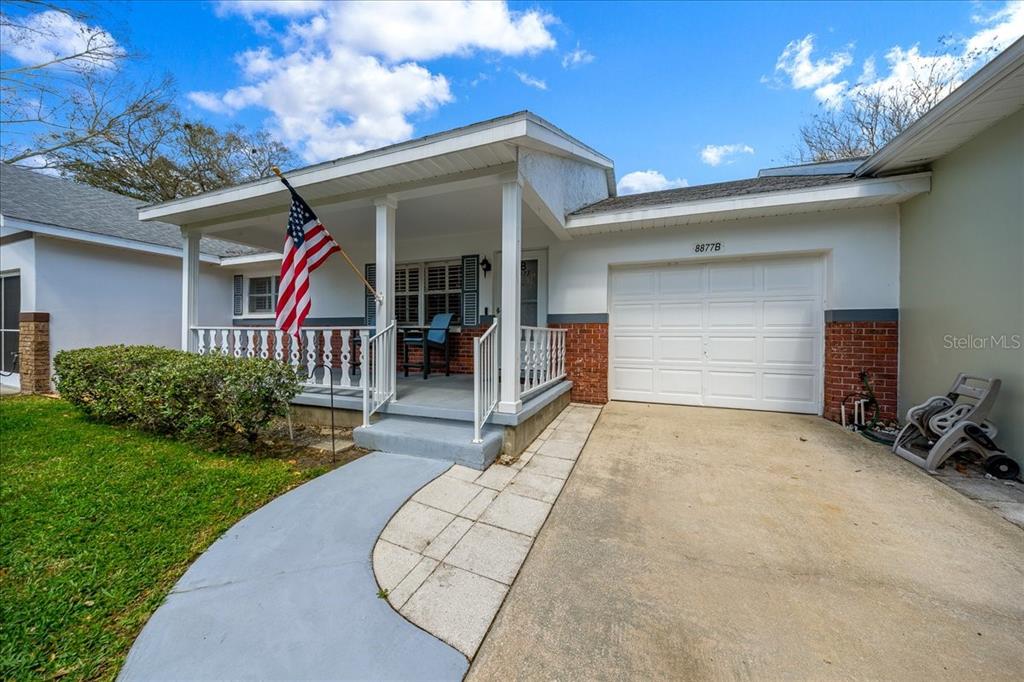 8877 Southwest 96th Street, Unit B Ocala, FL 34481 - Photo 4 of 48 a view of a house with porch and a yard