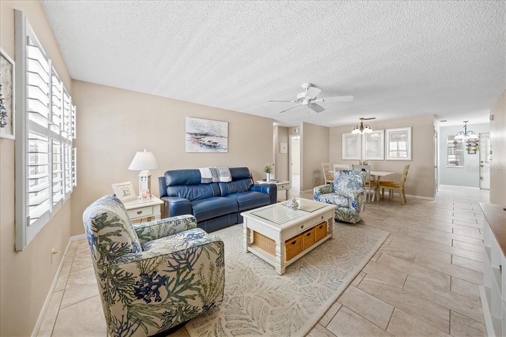 8877 Southwest 96th Street, Unit B Ocala, FL 34481 - Photo 7 of 48 a living room with furniture and a chandelier