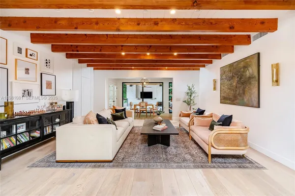 a living room with furniture and a floor to ceiling window