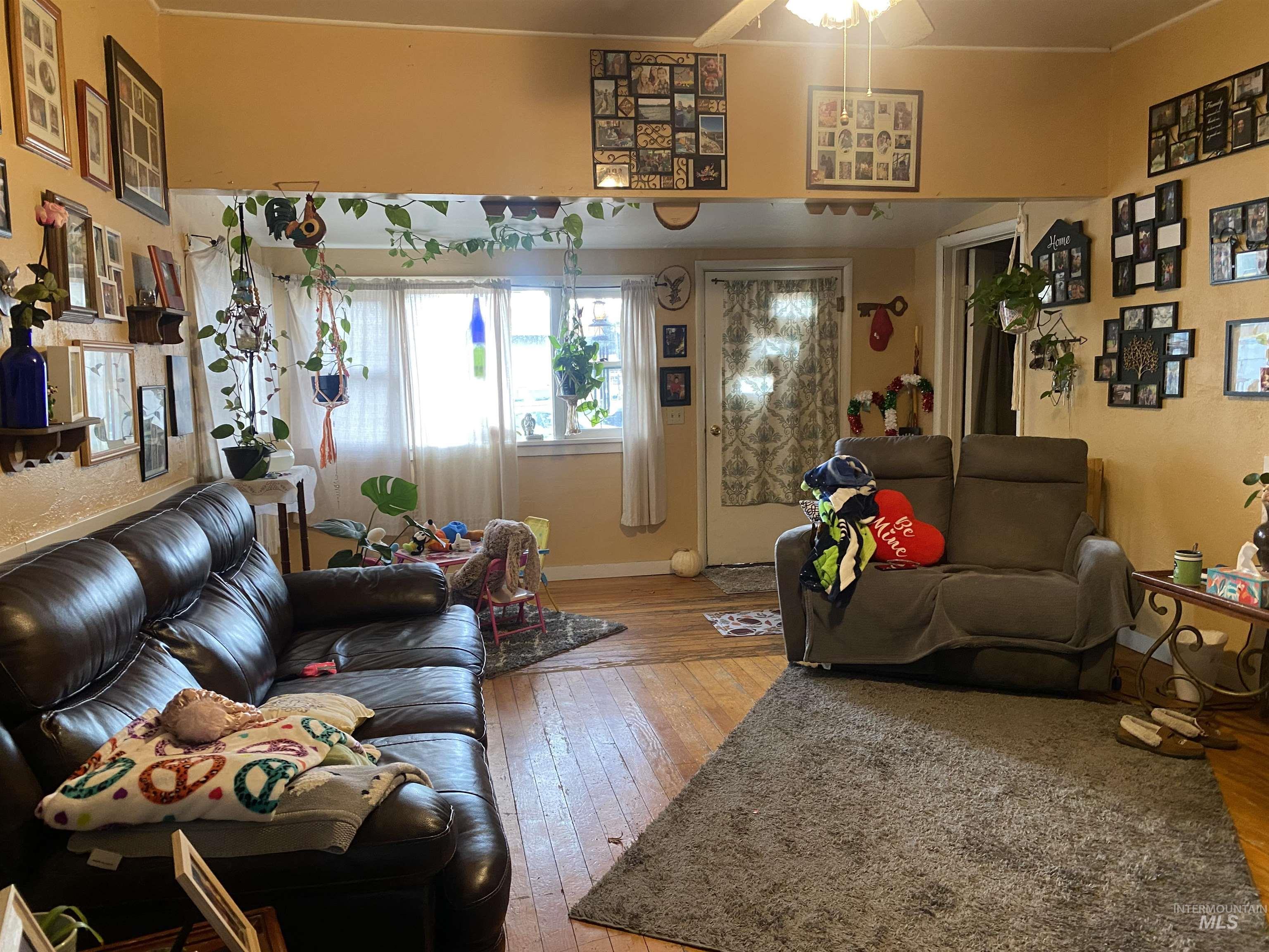 502 East Court Street Weiser, ID 83672 - Photo 2 of 17 Living area with light wood-style floors and ceiling fan