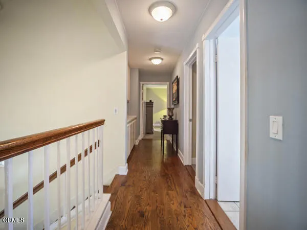 a view of hallway with wooden floor
