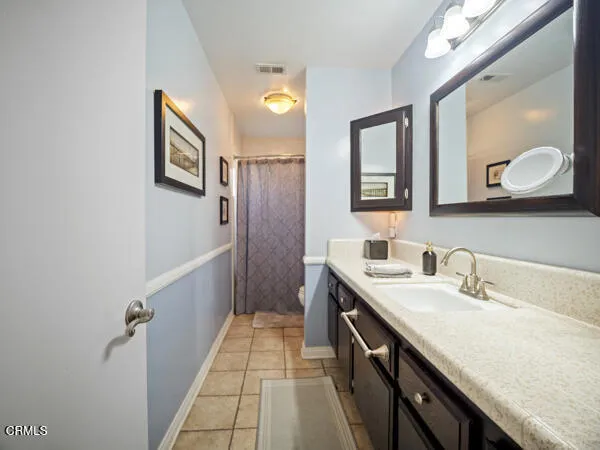 a spacious bathroom with a double vanity sink and a mirror