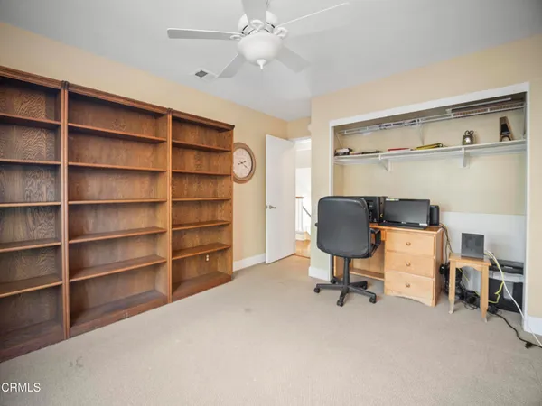 a view of a livingroom with workspace and a window
