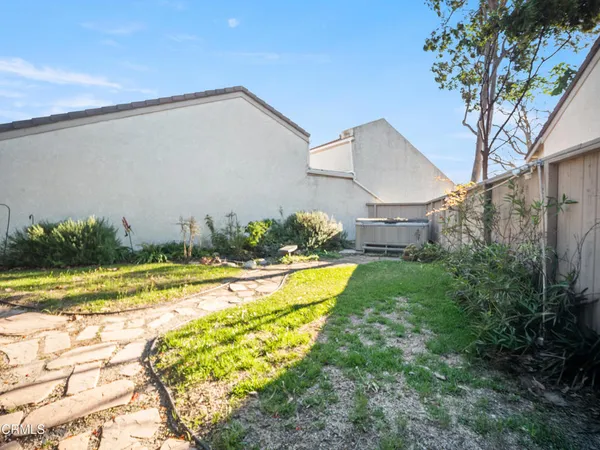a view of a house with pool and a yard