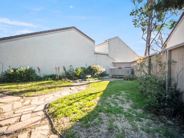 a view of a house with pool and a yard