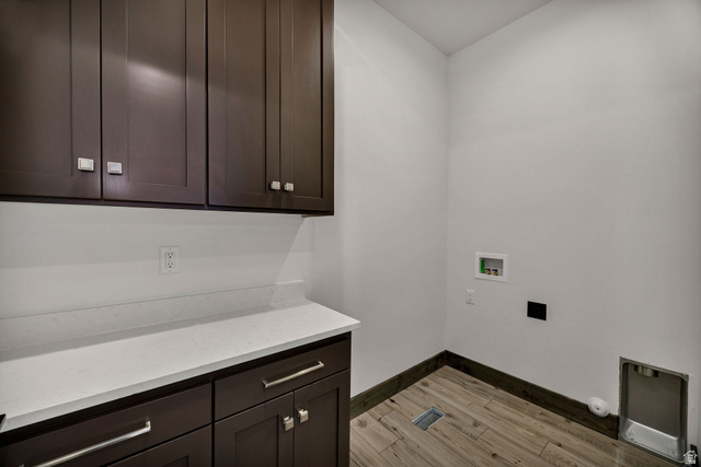 300 Knoll Loop, Unit 227 Fish Haven, ID 83287 - Photo 31 of 56 Laundry area with hookup for a washing machine, light wood-style floors, and cabinet space