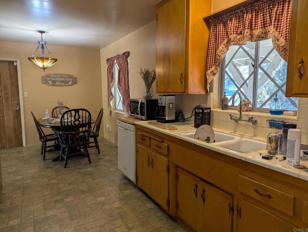 10309 Challenge Boulevard La Mesa, CA 91941 - Photo 3 of 51 a kitchen with a sink cabinets and dining table