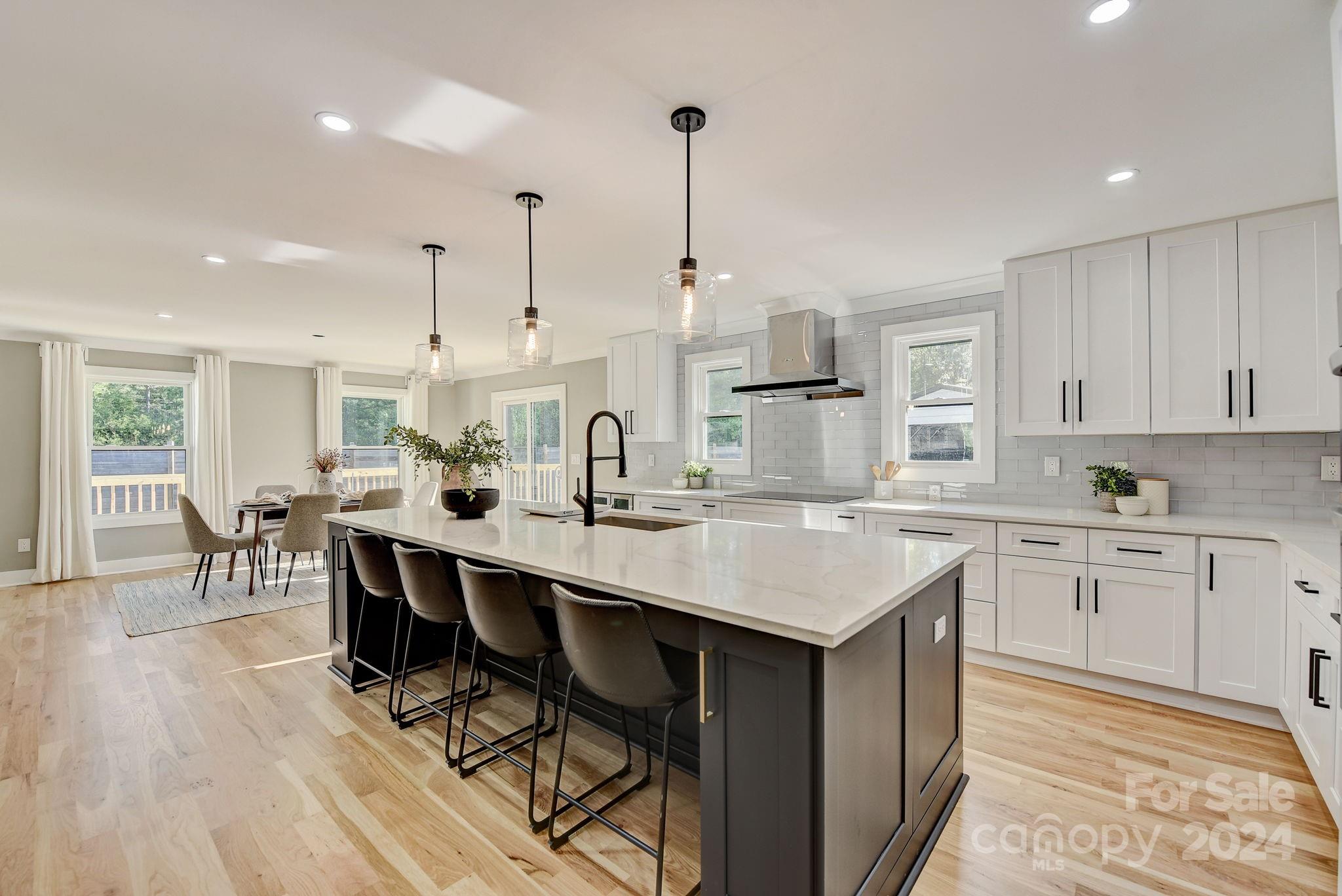 201 Potter Road Monroe, NC 28110 - Photo 11 of 44 a kitchen with stainless steel appliances kitchen island a island in the center and cabinets