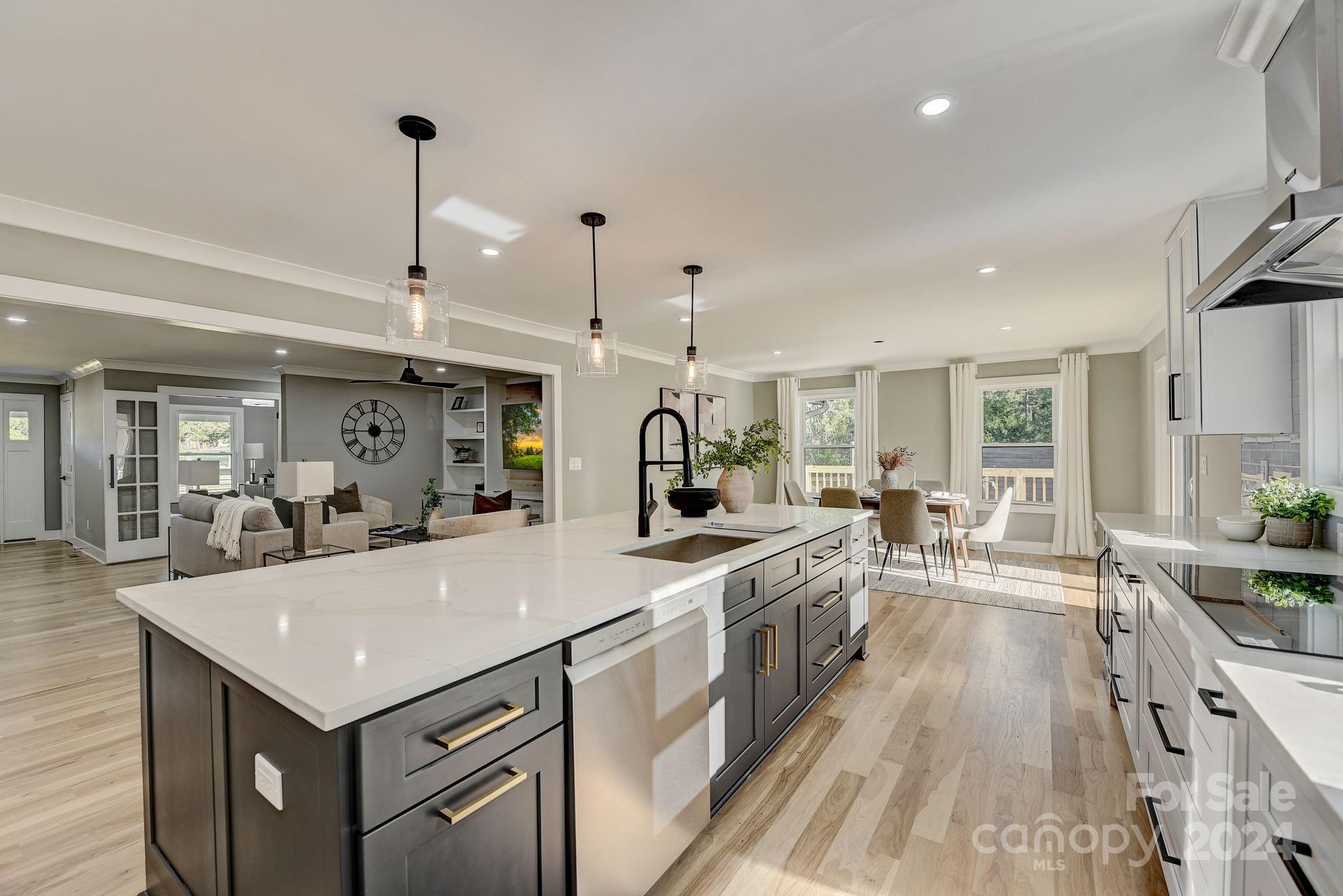 201 Potter Road Monroe, NC 28110 - Photo 12 of 44 a large kitchen with kitchen island a stove a sink a center island and couches