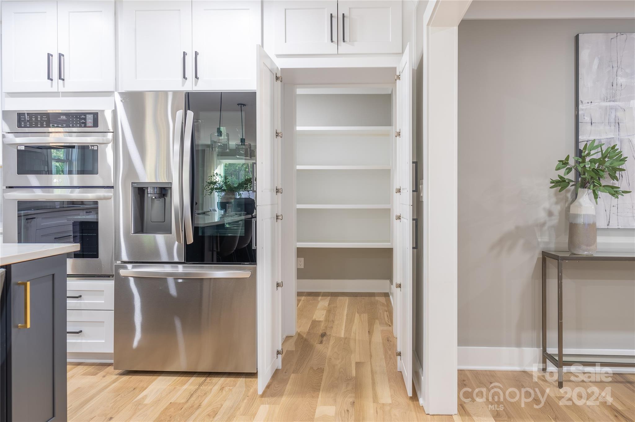 201 Potter Road Monroe, NC 28110 - Photo 14 of 44 a view of a refrigerator in kitchen and an empty room