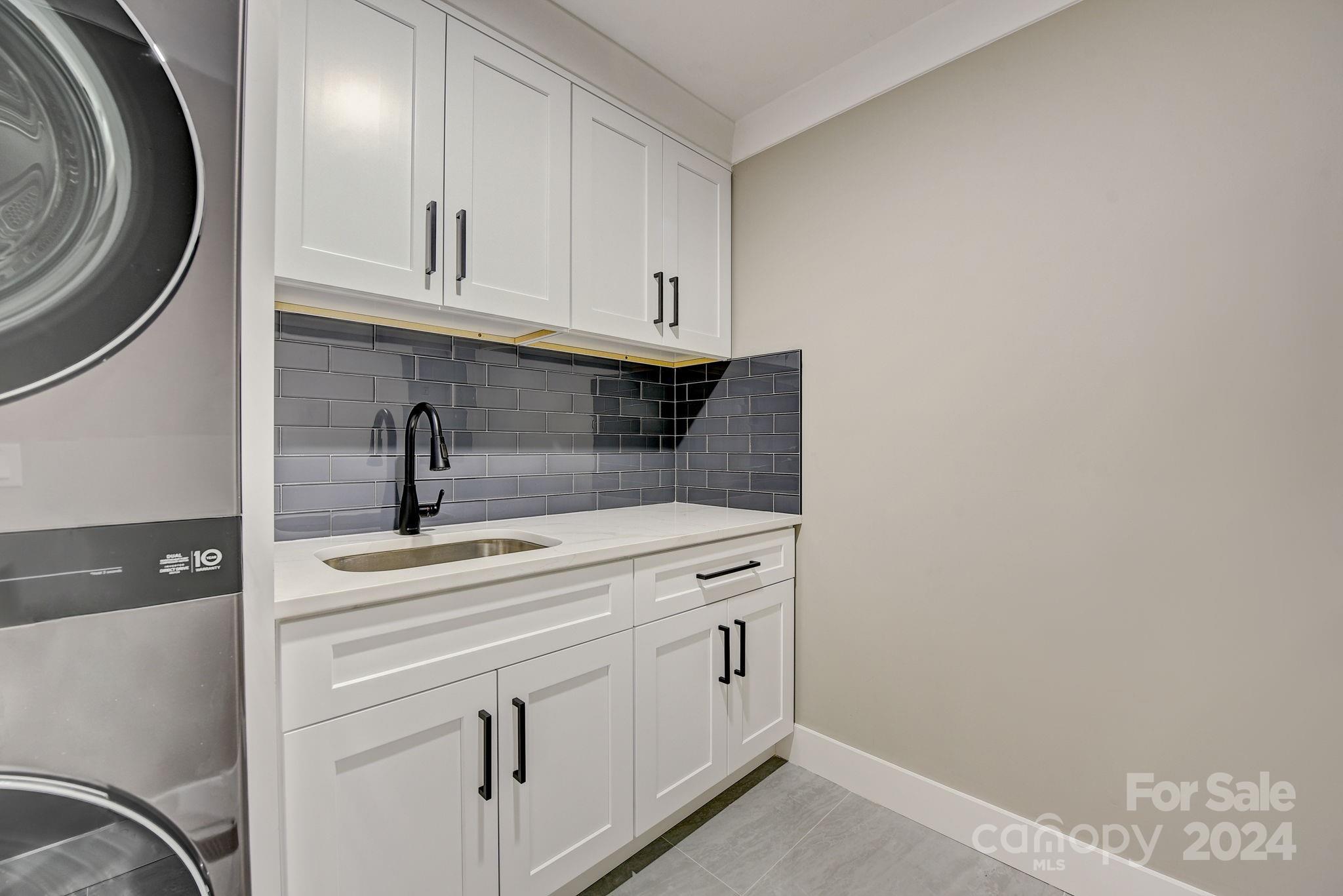 201 Potter Road Monroe, NC 28110 - Photo 18 of 44 a kitchen with white cabinets and sink