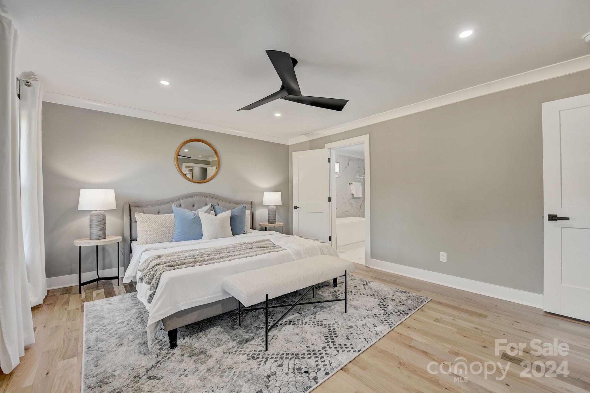 201 Potter Road Monroe, NC 28110 - Photo 20 of 44 a bedroom with a bed and a chandelier