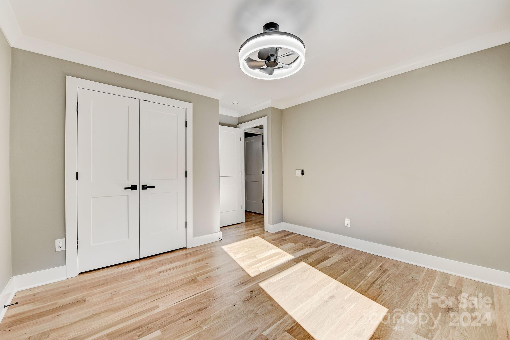 201 Potter Road Monroe, NC 28110 - Photo 26 of 44 an empty room with wooden floor and windows