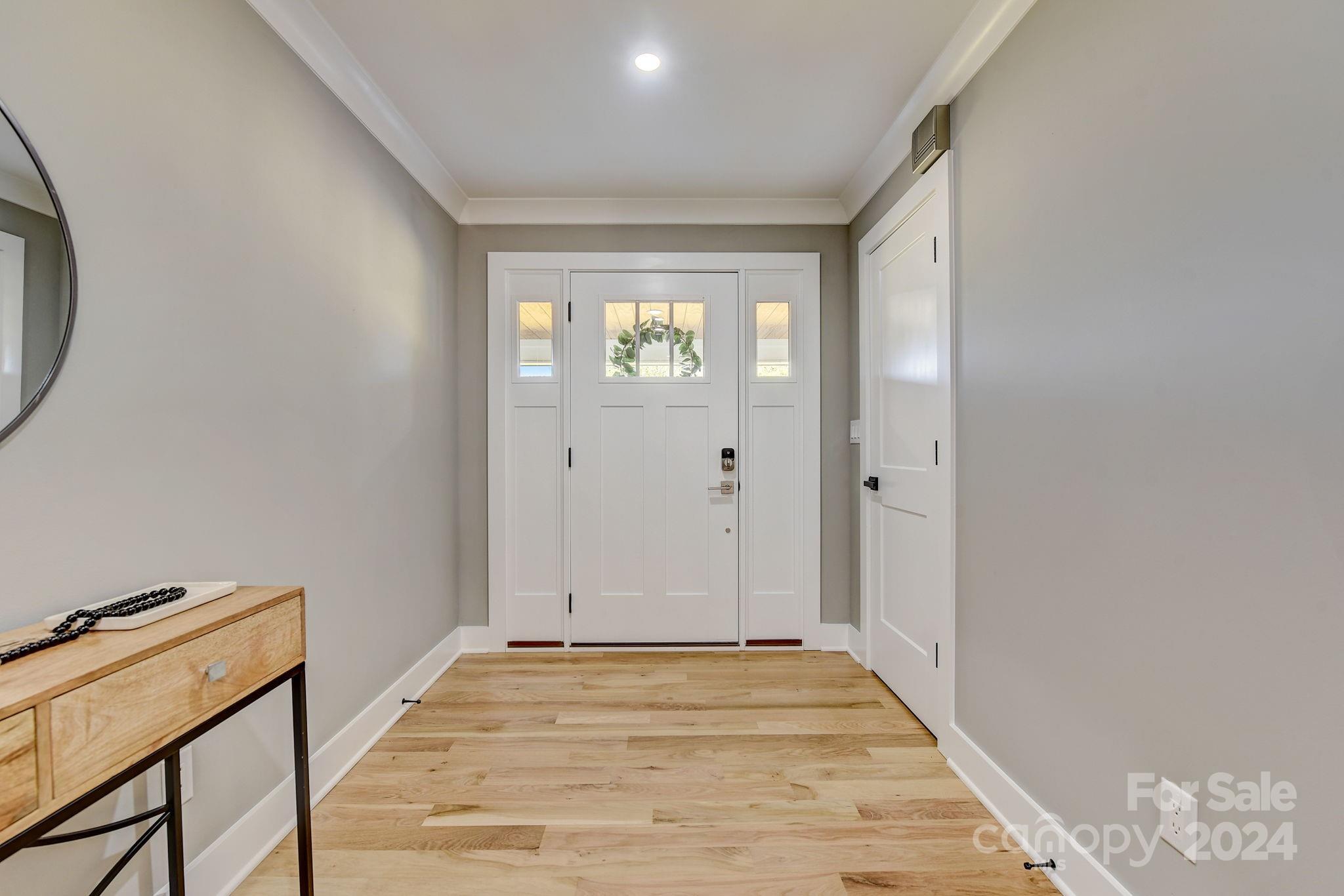 201 Potter Road Monroe, NC 28110 - Photo 6 of 44 a view of a hallway with wooden floor and a bathroom