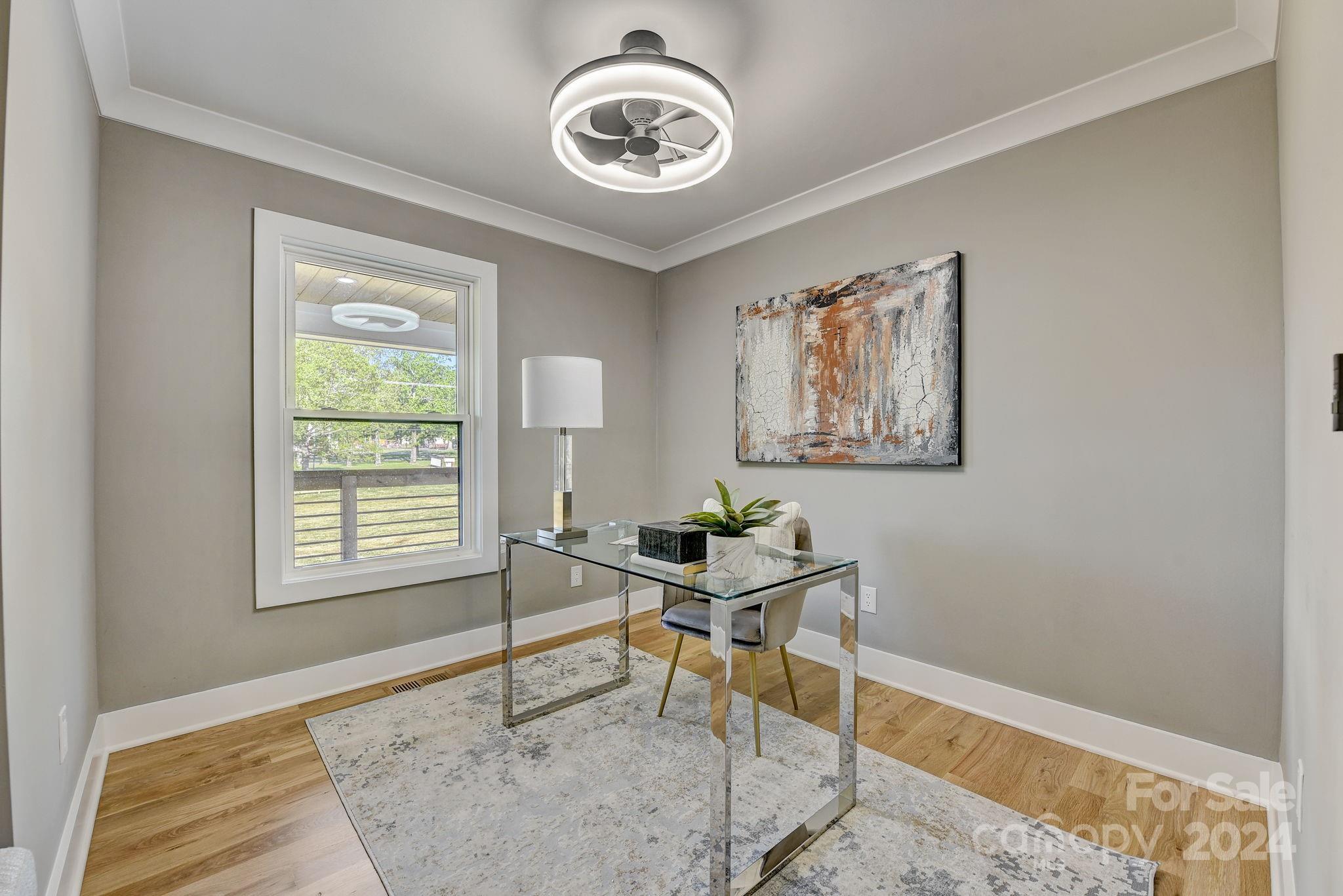 201 Potter Road Monroe, NC 28110 - Photo 9 of 44 a workspace with wooden floor and windows