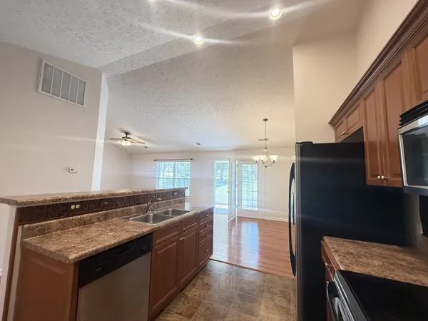 a kitchen with a sink and a refrigerator