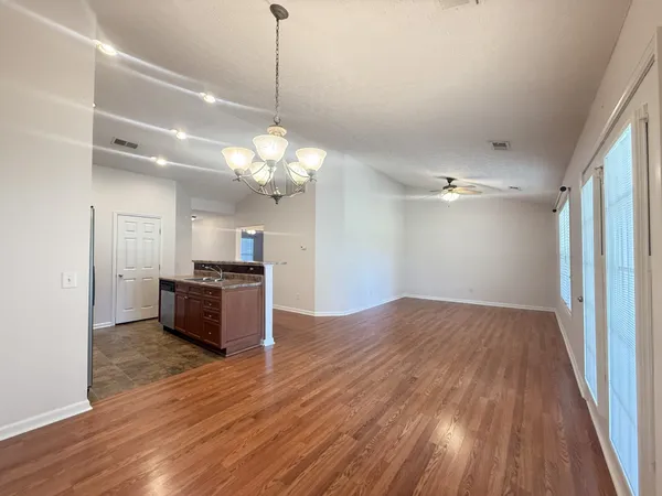 a view of a room with wooden floor