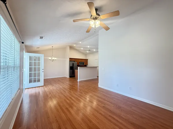 wooden floor in an empty room with a window