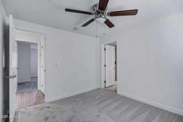 a bathroom with a toilet a sink a mirror and a window