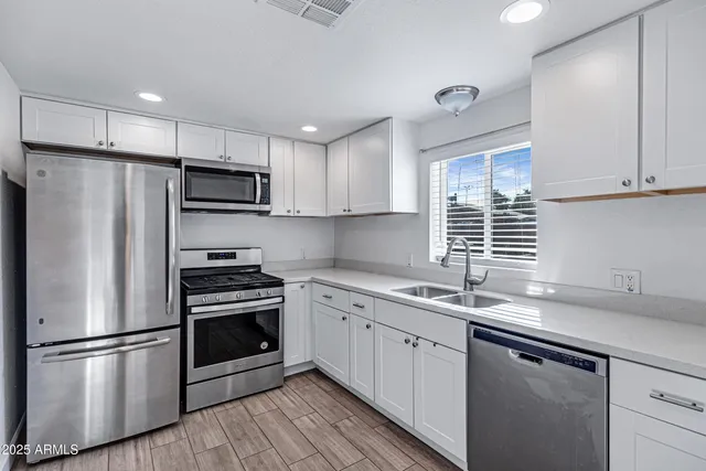 a kitchen with cabinets stainless steel appliances and cabinets