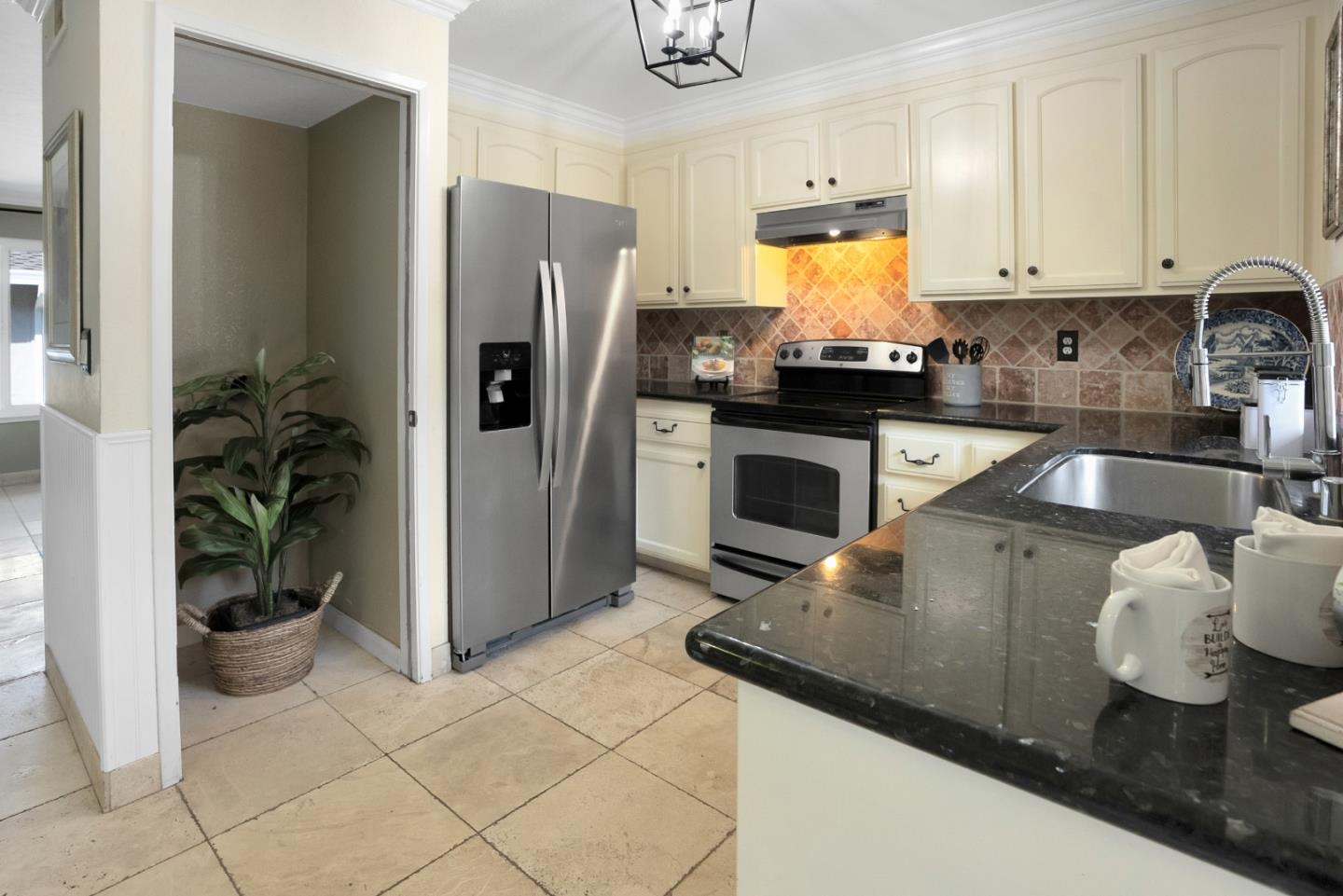 294 Bonefish Court Aptos, CA 95003 - Photo 11 of 27 a kitchen with granite countertop a stove and a refrigerator