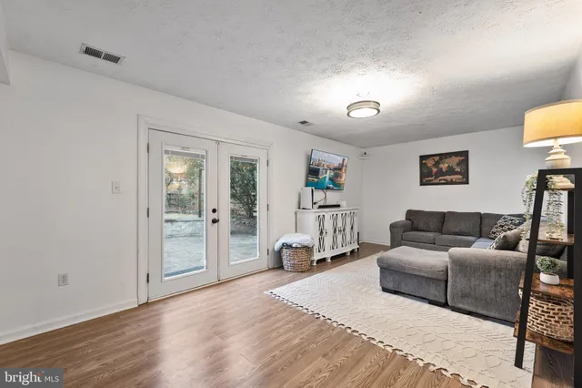 a living room with furniture and a lamp