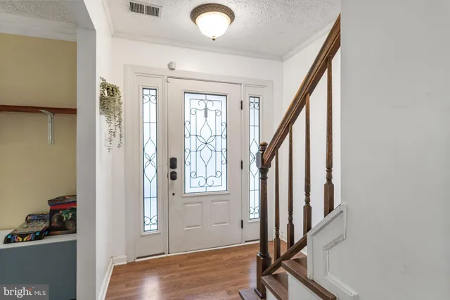 a view of an entryway with wooden floor and door